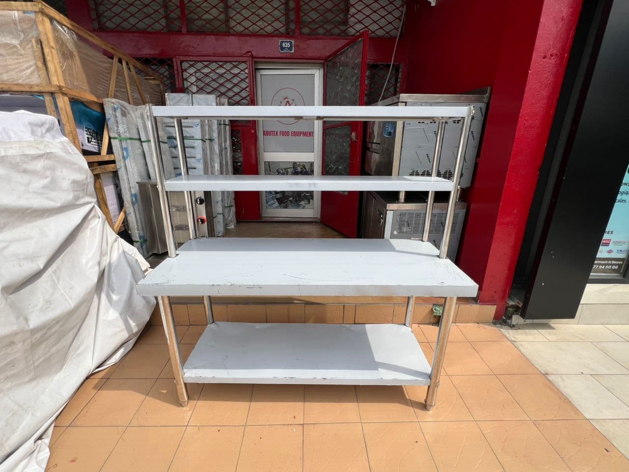 Stainless steel kitchen table with overhead shelf